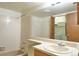 Bathroom features a vanity, mirror and tiled shower over tub combo at 8600 E Alameda Ave # 17-203, Denver, CO 80247