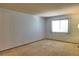 Bright bedroom with neutral carpet and a large window with natural light at 8600 E Alameda Ave # 17-203, Denver, CO 80247