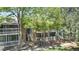 Exterior view of condo building featuring balconies, trees, and greenery at 8600 E Alameda Ave # 17-203, Denver, CO 80247