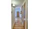 Hallway featuring wood floors leading to an open area with blue accent walls at 8600 E Alameda Ave # 17-203, Denver, CO 80247