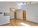 Spacious living room offers a view of the kitchen, wood floors, and natural light at 8600 E Alameda Ave # 17-203, Denver, CO 80247