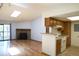 Open-concept living room featuring hardwood floors, fireplace, and kitchen access at 8600 E Alameda Ave # 17-203, Denver, CO 80247