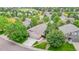 Aerial view of the home showcasing its manicured lawn and mature landscaping at 1229 Berganot Trl, Castle Pines, CO 80108