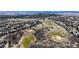 An aerial view of a golf course community surrounded by trees and houses, offering a serene and picturesque setting at 1229 Berganot Trl, Castle Pines, CO 80108