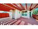 Backyard patio featuring a red patio pergola for shade, privacy fence, and abundant sunlight at 1229 Berganot Trl, Castle Pines, CO 80108