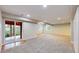 Spacious carpeted basement with recessed lighting and sliding glass doors to the outdoor patio at 1229 Berganot Trl, Castle Pines, CO 80108