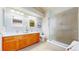 Bright bathroom with a double vanity, glass enclosed shower, and modern fixtures at 1229 Berganot Trl, Castle Pines, CO 80108