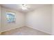 Carpeted bedroom with a window and ceiling fan, perfect for a relaxing space at 1229 Berganot Trl, Castle Pines, CO 80108