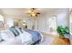 Spacious bedroom with a king-size bed, arched entryways, and a leafy potted plant at 1229 Berganot Trl, Castle Pines, CO 80108