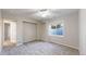 Bedroom showing carpet, window well and access door at 1229 Berganot Trl, Castle Pines, CO 80108