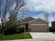 Charming single Gathering home showcasing a manicured front yard and attached garage in a desirable neighborhood at 1229 Berganot Trl, Castle Pines, CO 80108