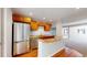 Kitchen boasts stainless steel appliances, granite countertops, and light wood cabinets at 1229 Berganot Trl, Castle Pines, CO 80108