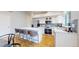 Well-equipped kitchen with white cabinets, granite countertops, stainless steel appliances, and center island at 1229 Berganot Trl, Castle Pines, CO 80108