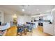 Spacious open kitchen with stainless steel appliances, a center island with seating, and an adjacent living area at 1229 Berganot Trl, Castle Pines, CO 80108