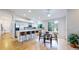 Bright kitchen features a large island with bar seating, stainless appliances, and an adjacent dining area at 1229 Berganot Trl, Castle Pines, CO 80108