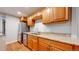 Basement kitchenette with wooden cabinets, stainless steel appliances, and granite countertops at 1229 Berganot Trl, Castle Pines, CO 80108