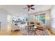 Bright open-concept living room with hardwood floors, views to the kitchen and access to the deck at 1229 Berganot Trl, Castle Pines, CO 80108