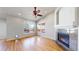 Cozy living room with hardwood floors, fireplace, large windows offering natural light at 1229 Berganot Trl, Castle Pines, CO 80108