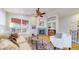 Cozy living room with fireplace, ceiling fan, and a view of the deck through a large window at 1229 Berganot Trl, Castle Pines, CO 80108