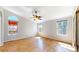 Spacious main bedroom with wood floors, many windows providing lots of light, and a ceiling fan at 1229 Berganot Trl, Castle Pines, CO 80108
