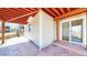 View of patio with painted floorboards and open-beam ceiling at 1229 Berganot Trl, Castle Pines, CO 80108