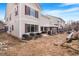 Exterior of home with a large backyard, patio with grill, and ready for landscaping at 11885 Helena St, Commerce City, CO 80022