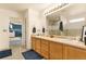 Primary bathroom featuring double sinks, vanity, and a large mirror at 11885 Helena St, Commerce City, CO 80022
