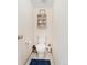 A half bath featuring a toilet and decorated with a cabinet, and art above the toilet at 11885 Helena St, Commerce City, CO 80022