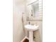 A half bath featuring a pedestal sink, and decorated with an anchor and other nautical art at 11885 Helena St, Commerce City, CO 80022
