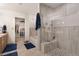 Ensuite bathroom featuring a stand-up glass shower, soaking tub, and entrance to the walk-in closet at 11885 Helena St, Commerce City, CO 80022