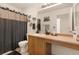 Hall bathroom featuring a vanity, single sink, and mirror at 11885 Helena St, Commerce City, CO 80022