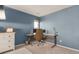 Bedroom with a dedicated workspace with a large desk and comfortable office chair at 11885 Helena St, Commerce City, CO 80022
