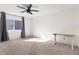 Bright bedroom with large windows, grey curtains, a ceiling fan, and a desk at 11885 Helena St, Commerce City, CO 80022
