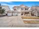 Charming two-story home with a three-car garage, a well-kept lawn, and a welcoming front porch at 11885 Helena St, Commerce City, CO 80022