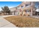 Beautiful home with well-manicured front yard, three-car garage, and a covered front porch at 11885 Helena St, Commerce City, CO 80022