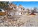 Attractive two-story home featuring stone accents, a three-car garage, and professional landscaping at 11885 Helena St, Commerce City, CO 80022
