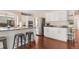 Modern kitchen featuring white cabinets, stainless steel appliances, and a breakfast bar with stools at 11885 Helena St, Commerce City, CO 80022