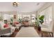 Inviting living room with comfortable seating, large windows, and a stylish hanging chair at 11885 Helena St, Commerce City, CO 80022