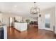 Open concept floorplan with the kitchen open to the living room and hardwood flooring throughout at 11885 Helena St, Commerce City, CO 80022