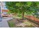 Lush backyard with a wooden fence, beautiful landscaping, and mature tree at 942 Xenon Ct, Golden, CO 80401