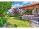 Spacious backyard features a covered deck, lush lawn, and mature landscaping, creating a serene outdoor retreat at 942 Xenon Ct, Golden, CO 80401