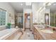 Luxurious bathroom with double sinks, vanity, soaking tub, and glass-enclosed shower at 942 Xenon Ct, Golden, CO 80401