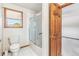 Clean bathroom with a tiled shower and a toilet; natural light from the window at 942 Xenon Ct, Golden, CO 80401