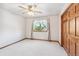 Bright bedroom with a window, neutral carpet, and trim, perfect for customization at 942 Xenon Ct, Golden, CO 80401