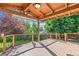 Enjoy outdoor living on this covered deck featuring wood beams, a ceiling fan, and views of the landscaped backyard at 942 Xenon Ct, Golden, CO 80401