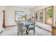 Bright dining room with large windows, a modern chandelier, and a glass-top table at 942 Xenon Ct, Golden, CO 80401