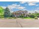 Beautiful home with a brick facade, covered porch, and manicured lawn, offering timeless curb appeal at 942 Xenon Ct, Golden, CO 80401