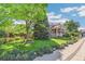 Charming home with a well-manicured front yard and mature trees, creating a picturesque curb appeal at 942 Xenon Ct, Golden, CO 80401