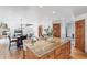 Open kitchen layout with granite island, seating, and an adjacent dining and living area at 942 Xenon Ct, Golden, CO 80401