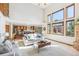 Bright living room featuring soaring ceilings, large windows, and an open layout connecting to the kitchen at 942 Xenon Ct, Golden, CO 80401